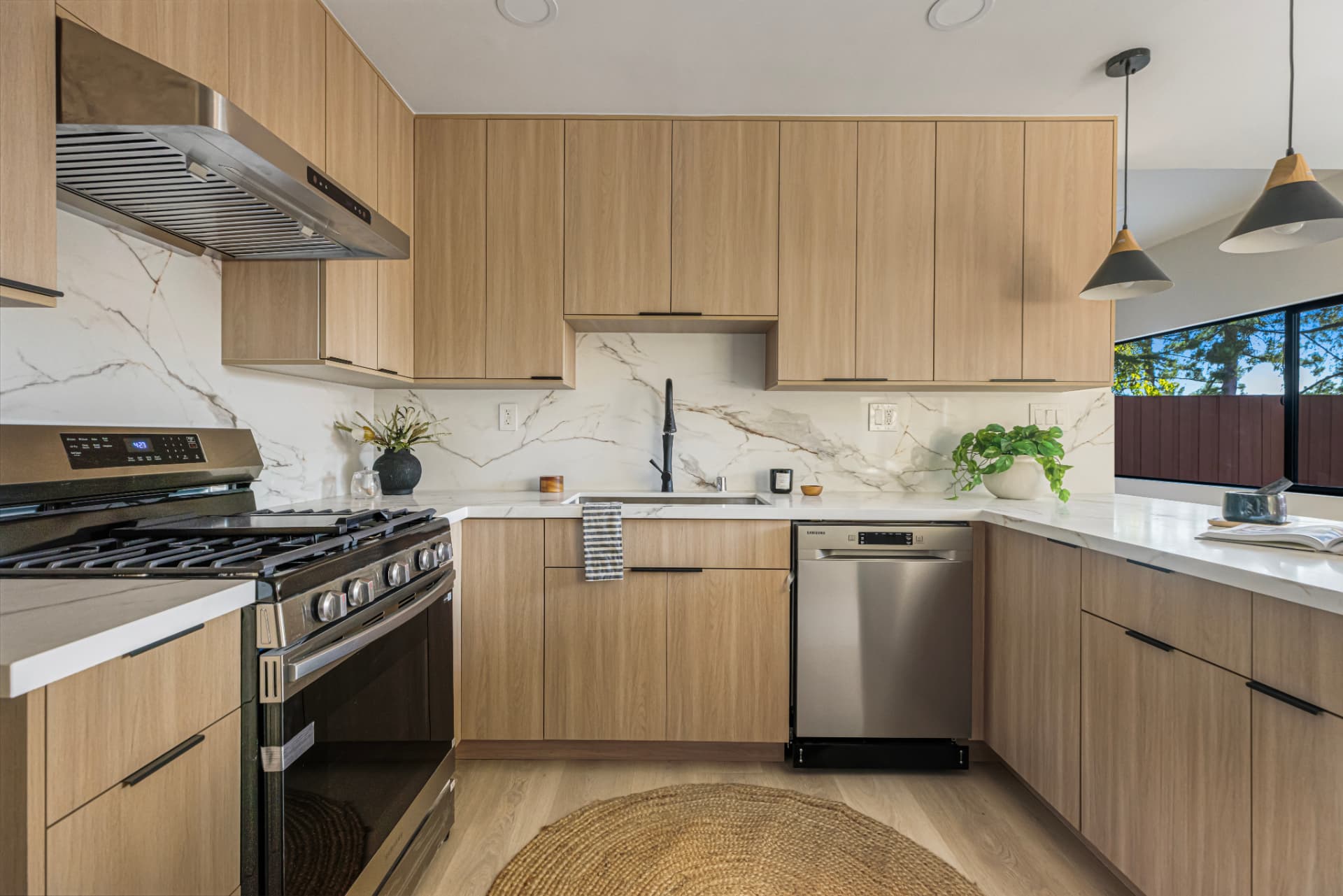 Range wall with stone backsplash and stainless appliances