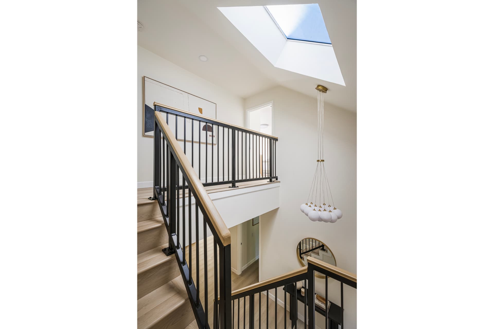 Skylit stairwell with cluster pendant