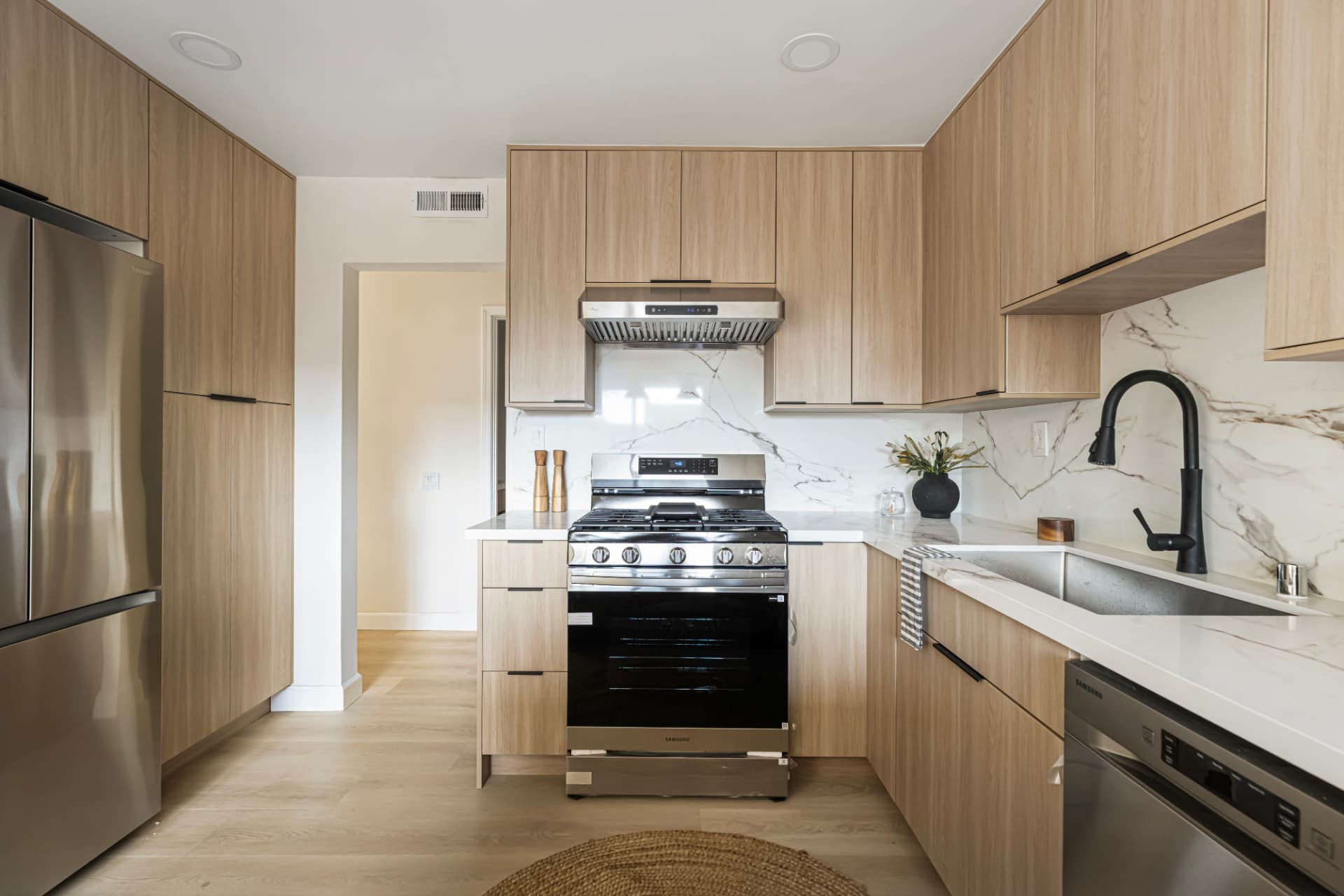 Kitchen with counter-depth refrigerator and gas range