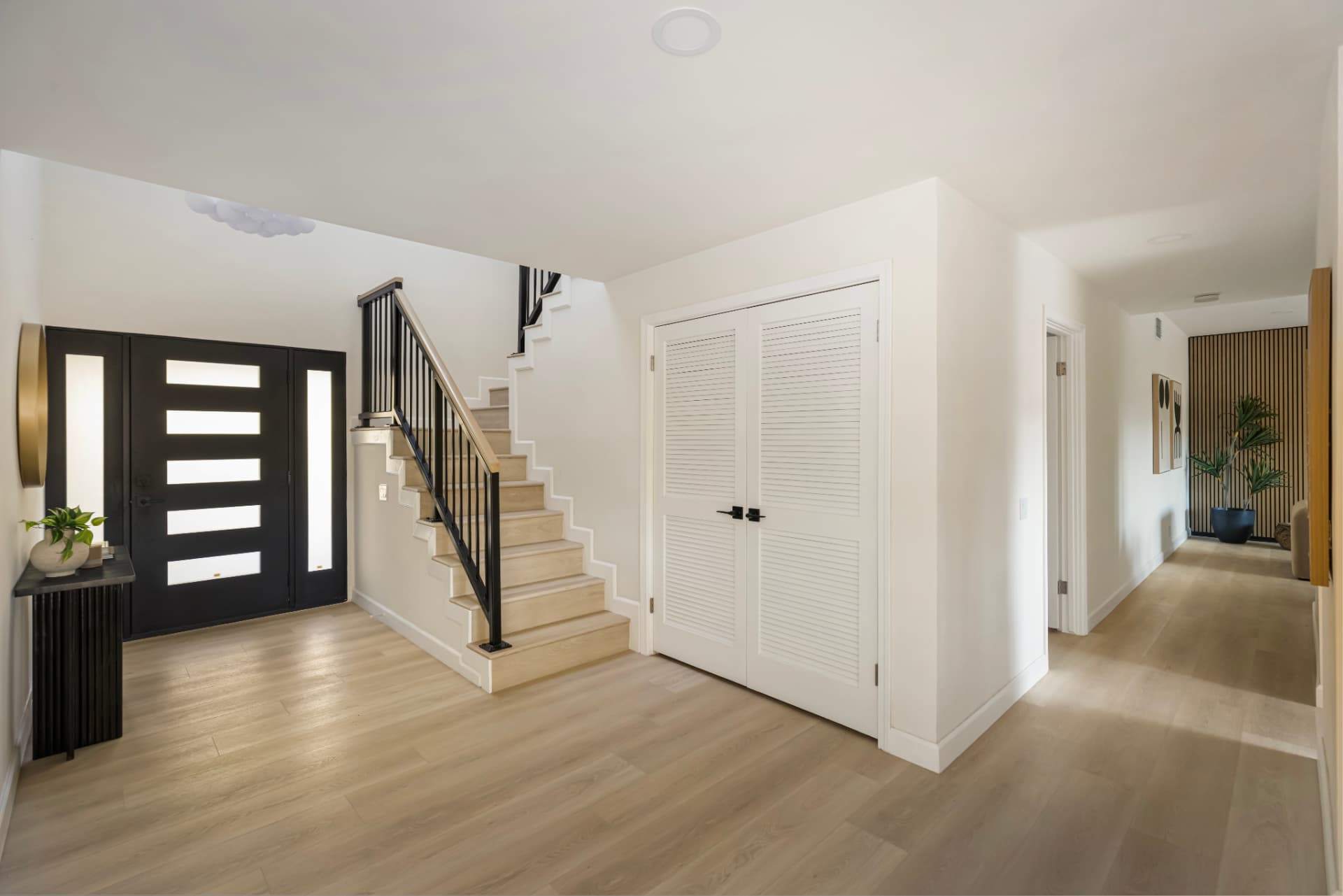 Foyer looking down the hall toward the wood slat feature wall