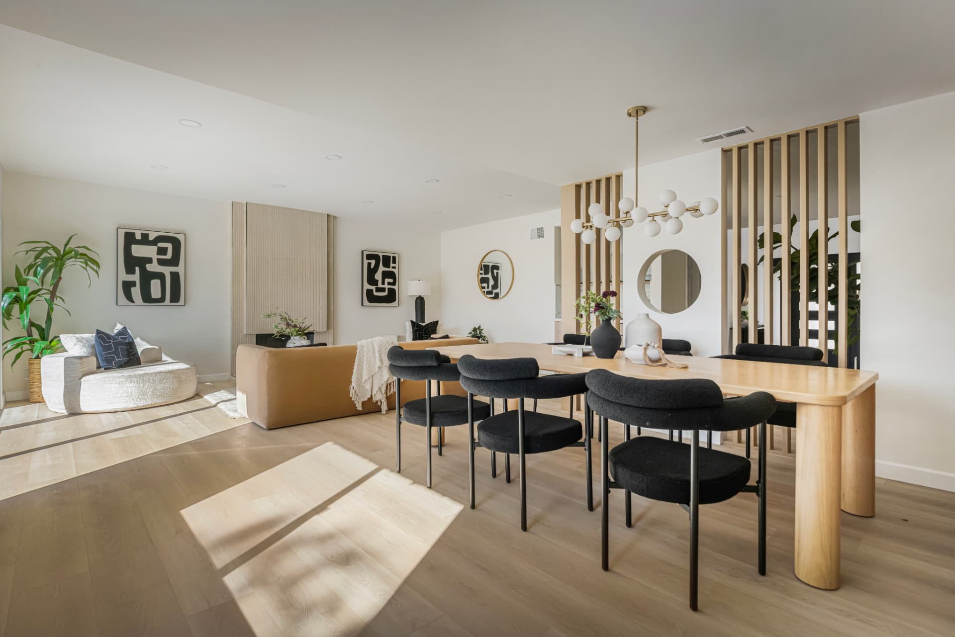 Open dining and living room with sculptural wood table
